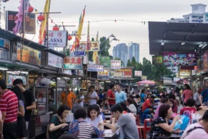 Penang hawker center with multiple food stalls and vendors preparing street food